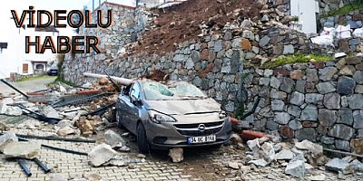 Turgutreis' te  istinat duvarı otomobilin üzerine çöktü iki kişi ölümden döndü